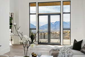 Entryway with hardwood flooring, a mountain view, and French doors