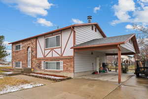 View of front of house with a carport