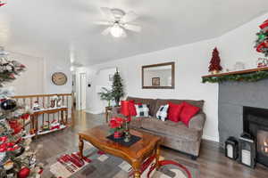 Living room featuring dark hardwood / wood-style flooring and ceiling fan