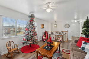 Living room with hardwood / wood-style flooring and ceiling fan