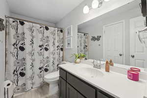 Bathroom with vanity, hardwood / wood-style flooring, toilet, and walk in shower