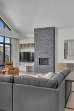 Living room featuring light hardwood / wood-style floors, a fireplace, and vaulted ceiling