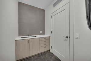 Bathroom featuring vanity and tile walls