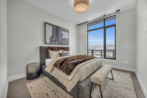 Bedroom featuring a mountain view and dark hardwood / wood-style flooring