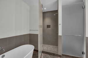 Bathroom with separate shower and tub and tile walls