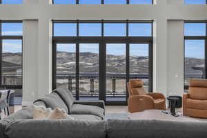 Living room featuring a mountain view, hardwood / wood-style floors, and plenty of natural light