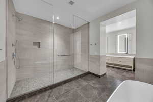 Bathroom featuring vanity and shower with separate bathtub