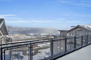 View of snow covered back of property