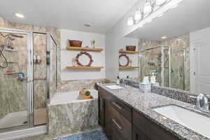 Master Bathroom with vanity and shower with separate bathtub