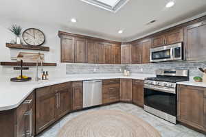 Kitchen featuring decorative backsplash, and stainless steel appliances