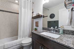 Full bathroom with vanity, shower / bathtub combination.