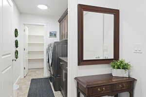 Washroom with cabinets and washing machine and dryer