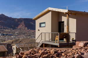 View of home's exterior with a mountain view and a balcony