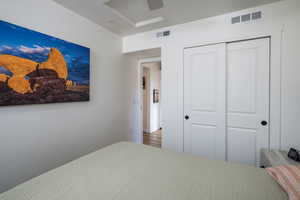 Bedroom featuring ceiling fan, a closet, and hardwood / wood-style floors