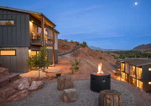 Yard at dusk with a fire pit and a mountain view