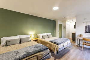 Bedroom featuring wood-type flooring