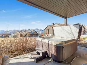 View of patio / terrace with a mountain view and a hot tub