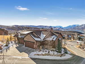 View of front of property with a mountain view and a garage