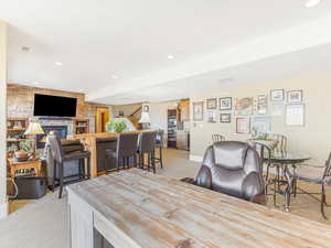 Carpeted dining room featuring a fireplace