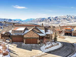 View of front of house with a mountain view and a garage