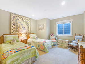 Bedroom featuring light colored carpet