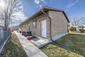 View of home's exterior with a yard and central AC unit