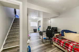 Living room with hardwood / wood-style flooring and a textured ceiling