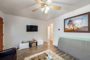 Living room with hardwood / wood-style flooring and ceiling fan