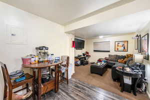 Living room featuring electric panel and dark hardwood / wood-style floors