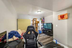 Living room with dark hardwood / wood-style flooring and a textured ceiling