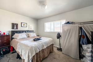 Bedroom with light colored carpet