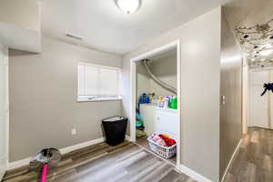 Laundry room featuring washer / dryer and hardwood / wood-style flooring