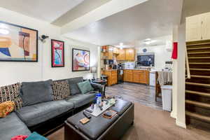 Carpeted living room with a textured ceiling