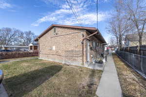 View of home's exterior with a yard and a patio