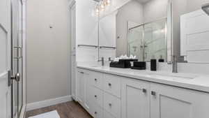 Bathroom featuring vanity and a shower with shower door