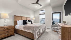 Carpeted bedroom with access to outside, high vaulted ceiling, and ceiling fan