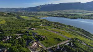 Aerial view of property's location featuring a water and mountain view