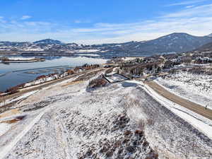 Snowy aerial view with a water and mountain view