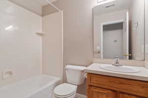 Full bathroom with vanity, toilet, and shower / bath combination