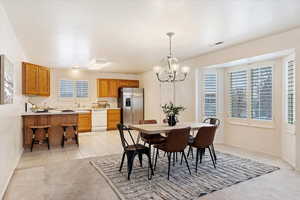 Dining area featuring light carpet and an inviting chandelier