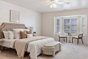 Carpeted bedroom with ceiling fan