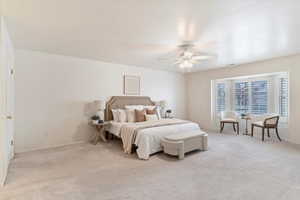 Carpeted bedroom with ceiling fan