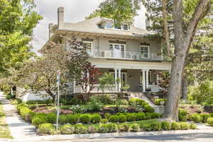 View of front of house featuring a balcony and a porch