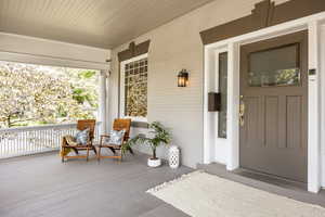 View of exterior entry with covered porch