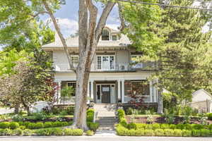 View of front of house featuring a porch and a balcony