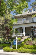 Exterior space featuring a porch and a balcony