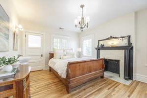 Bedroom featuring light hardwood / wood-style flooring and a chandelier