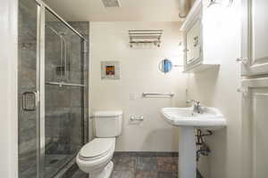 Bathroom with walk in shower, sink, and toilet