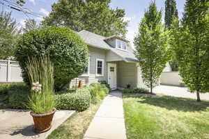 View of front of home with a front lawn and a garage