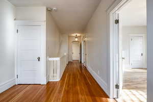 Hall with hardwood / wood-style flooring